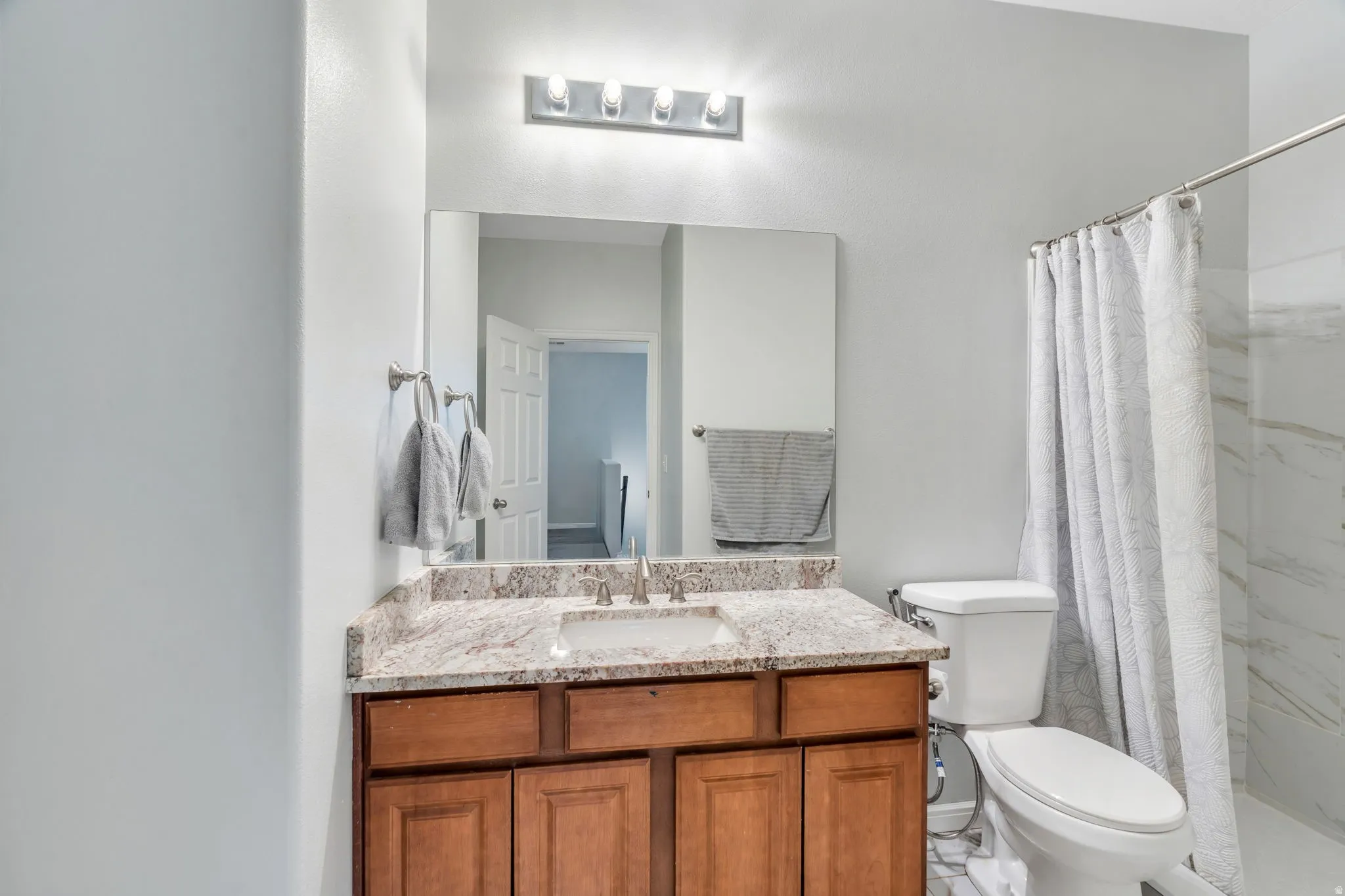 Large walk-in shower & rich cabinetry