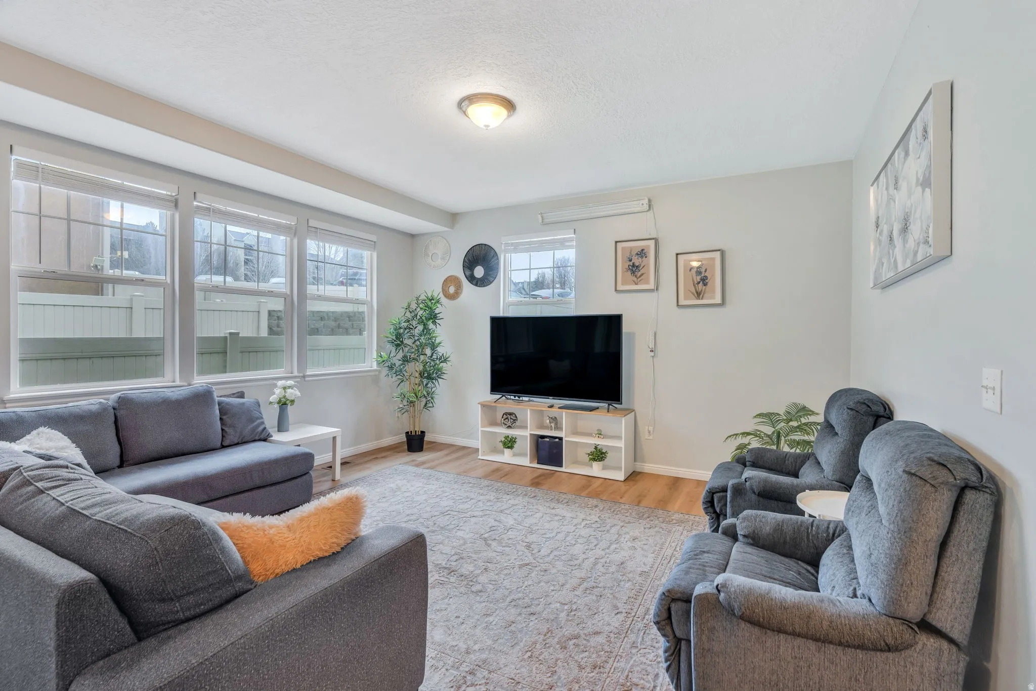 A bright open great room with room for both entertaining & relaxing while connecting to the main living areas