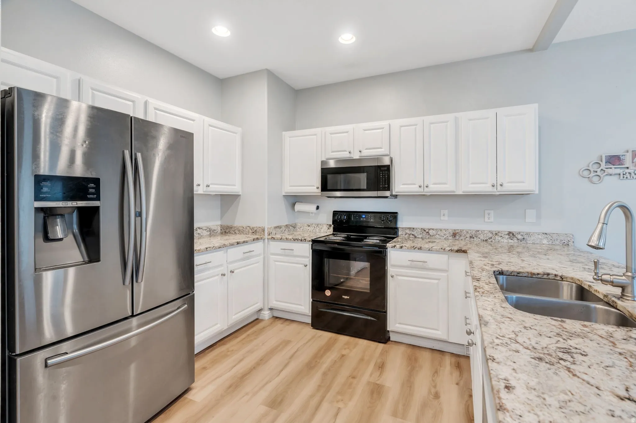 Crisp white cabinetry with granite countertops