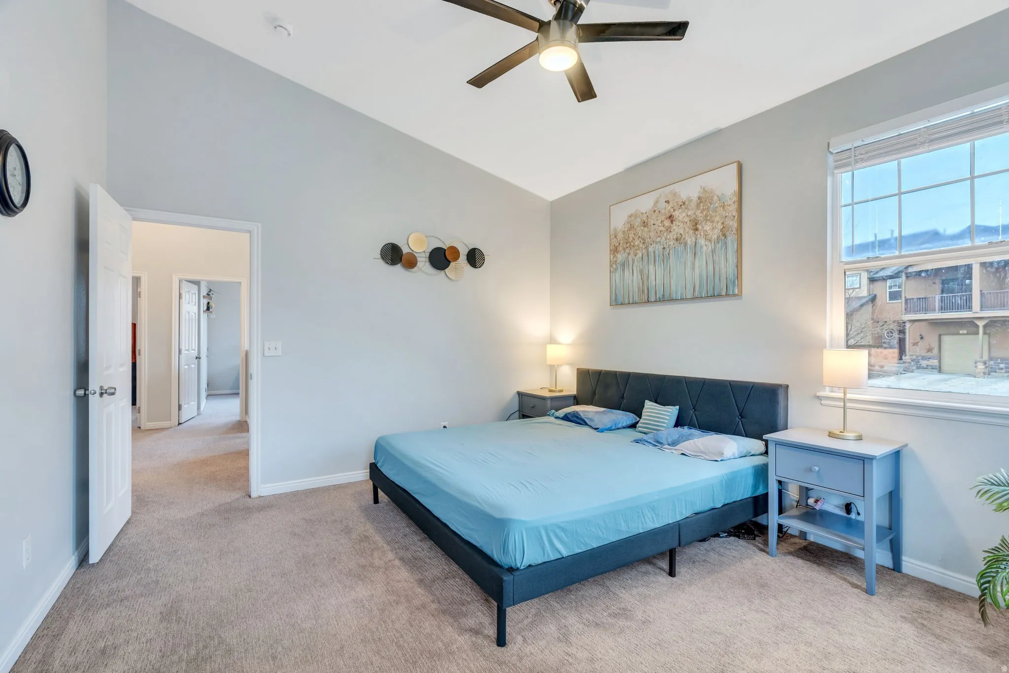 Soft neutral wall color and vaulted ceiling give this primary a open feel.