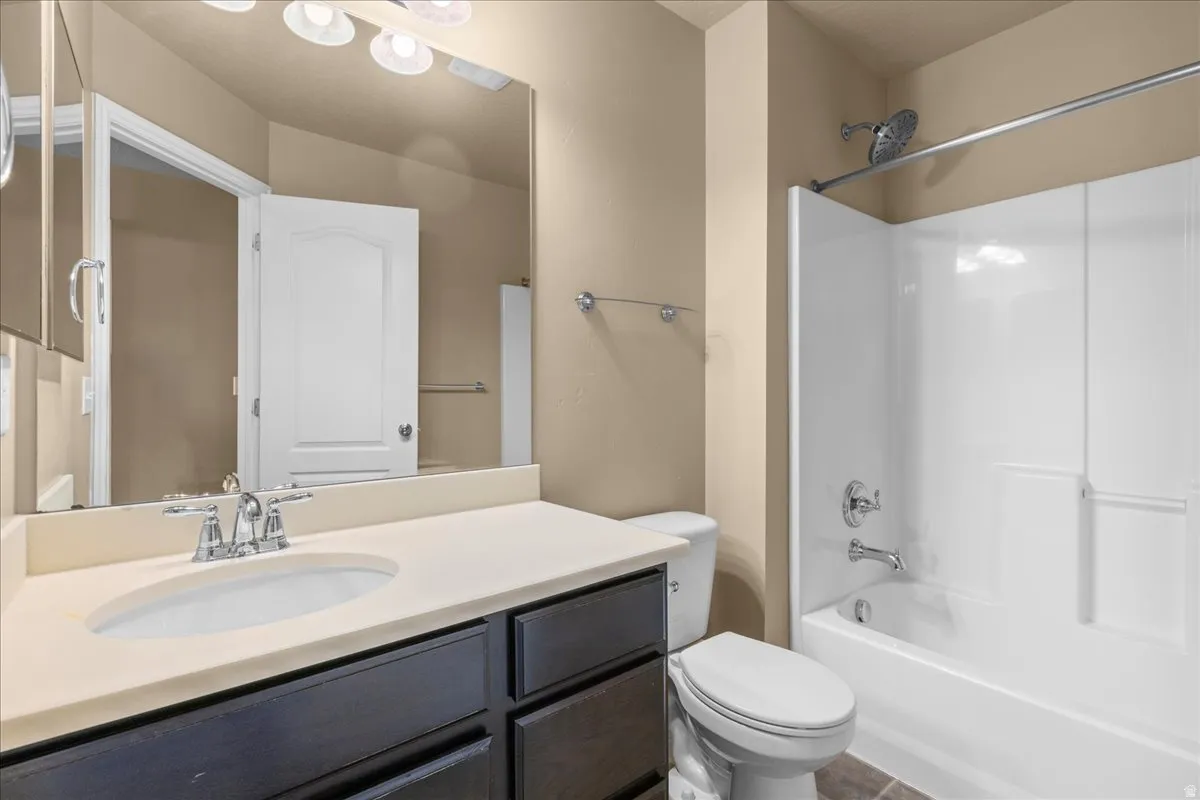 Bathroom with vanity and washtub / shower combination