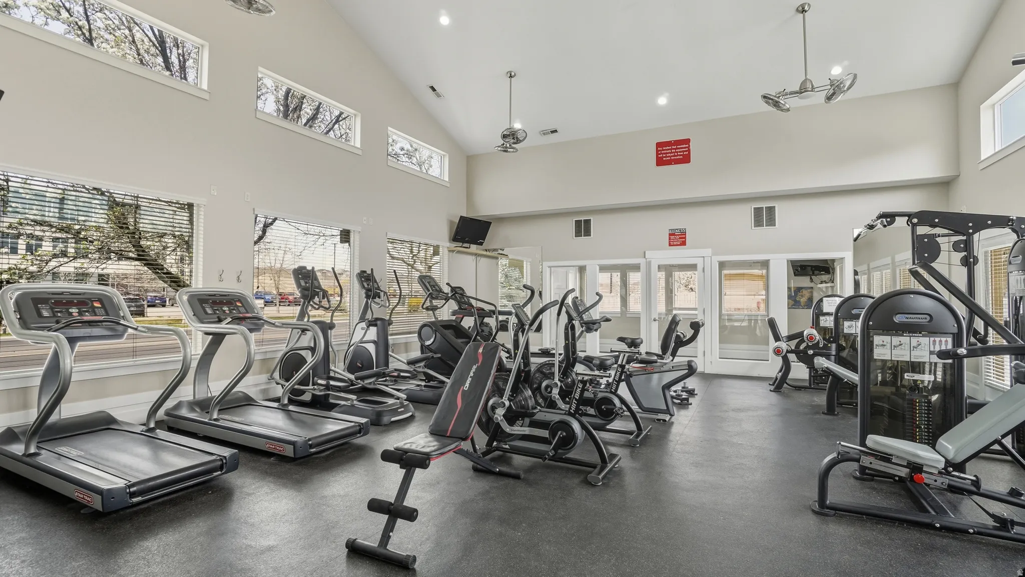Workout area with vaulted ceiling and recessed lighting