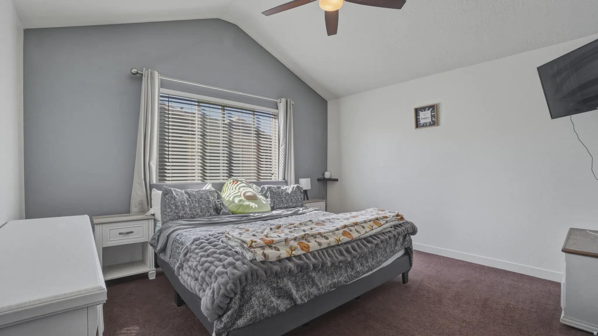 Bedroom featuring dark colored carpet and a ceiling fan