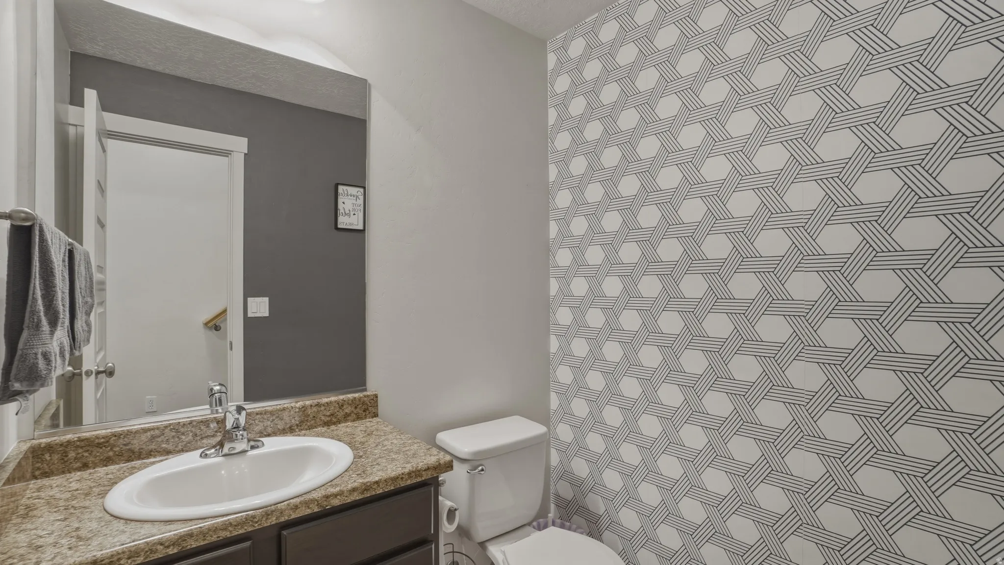 Half bathroom with vanity and toilet