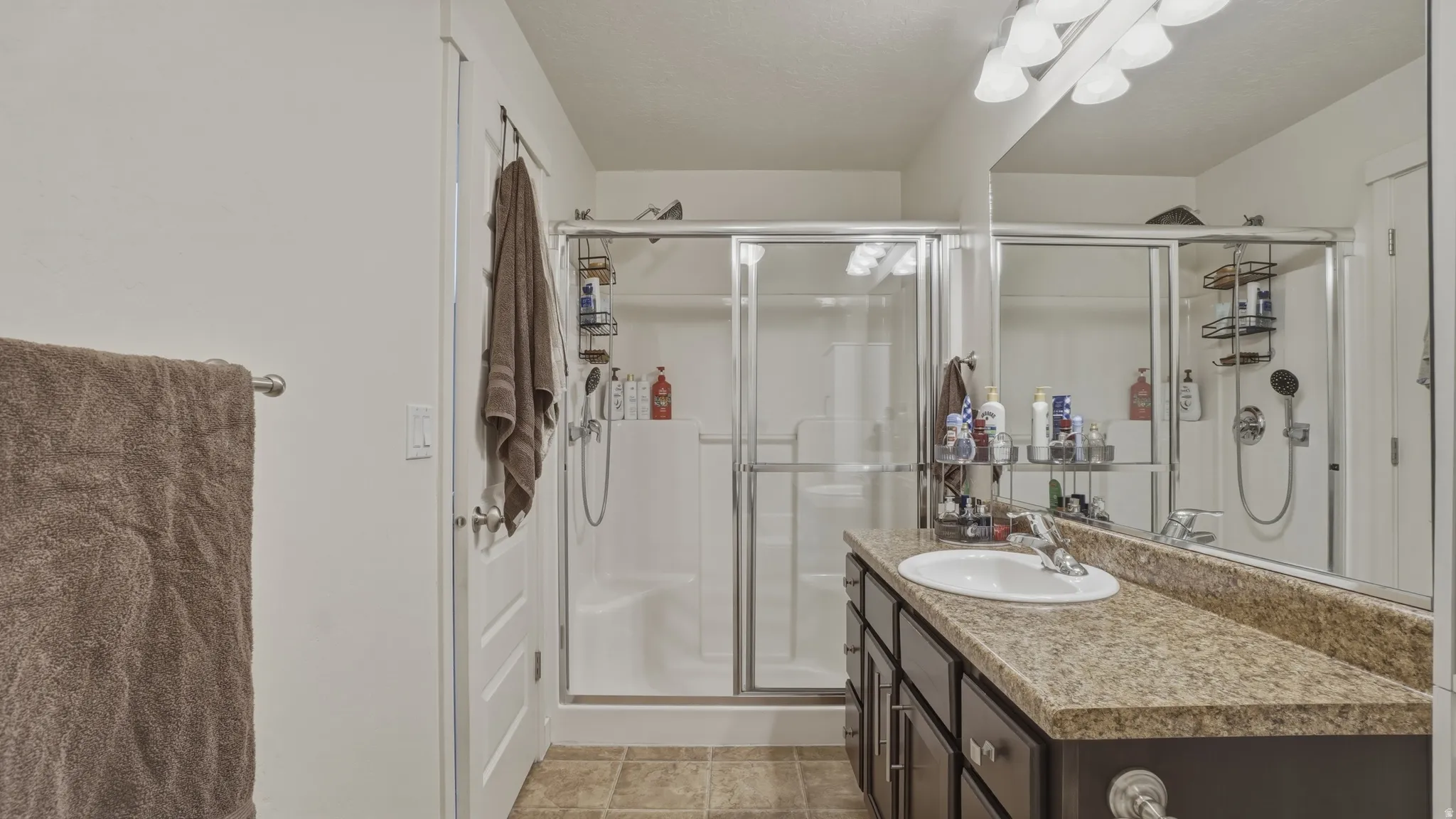 Bathroom featuring vanity and a shower stall