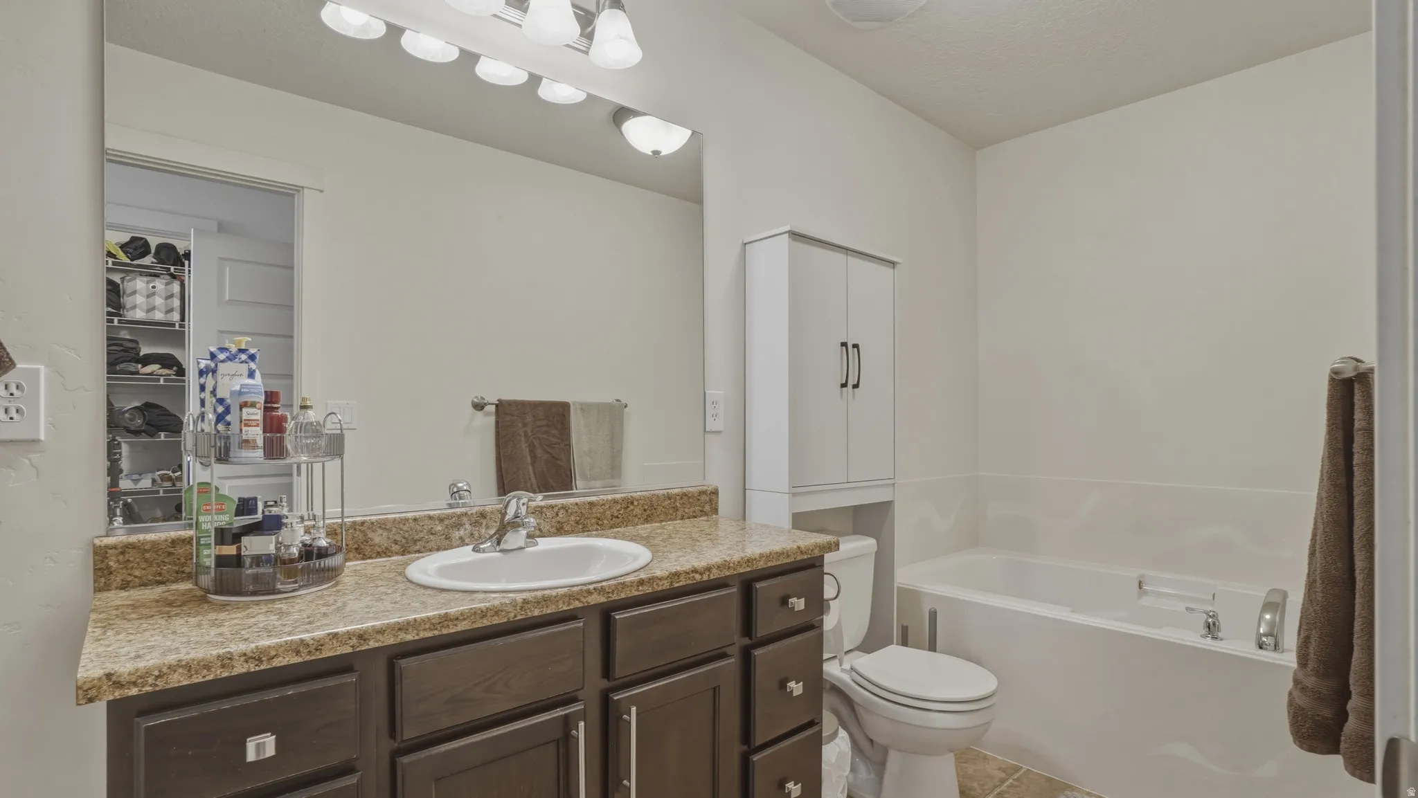 Full bath with vanity and a bath