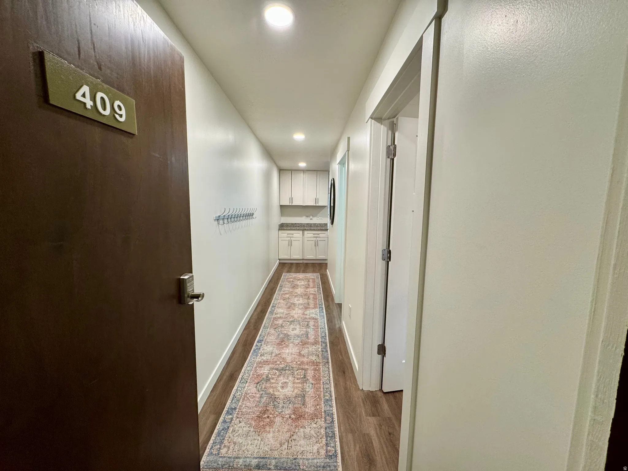 Corridor with recessed lighting and dark wood-type flooring