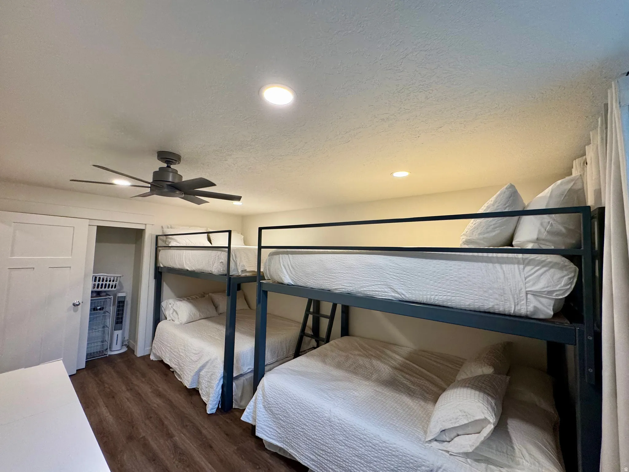 Bedroom with recessed lighting, dark wood-style floors, a textured ceiling, and ceiling fan