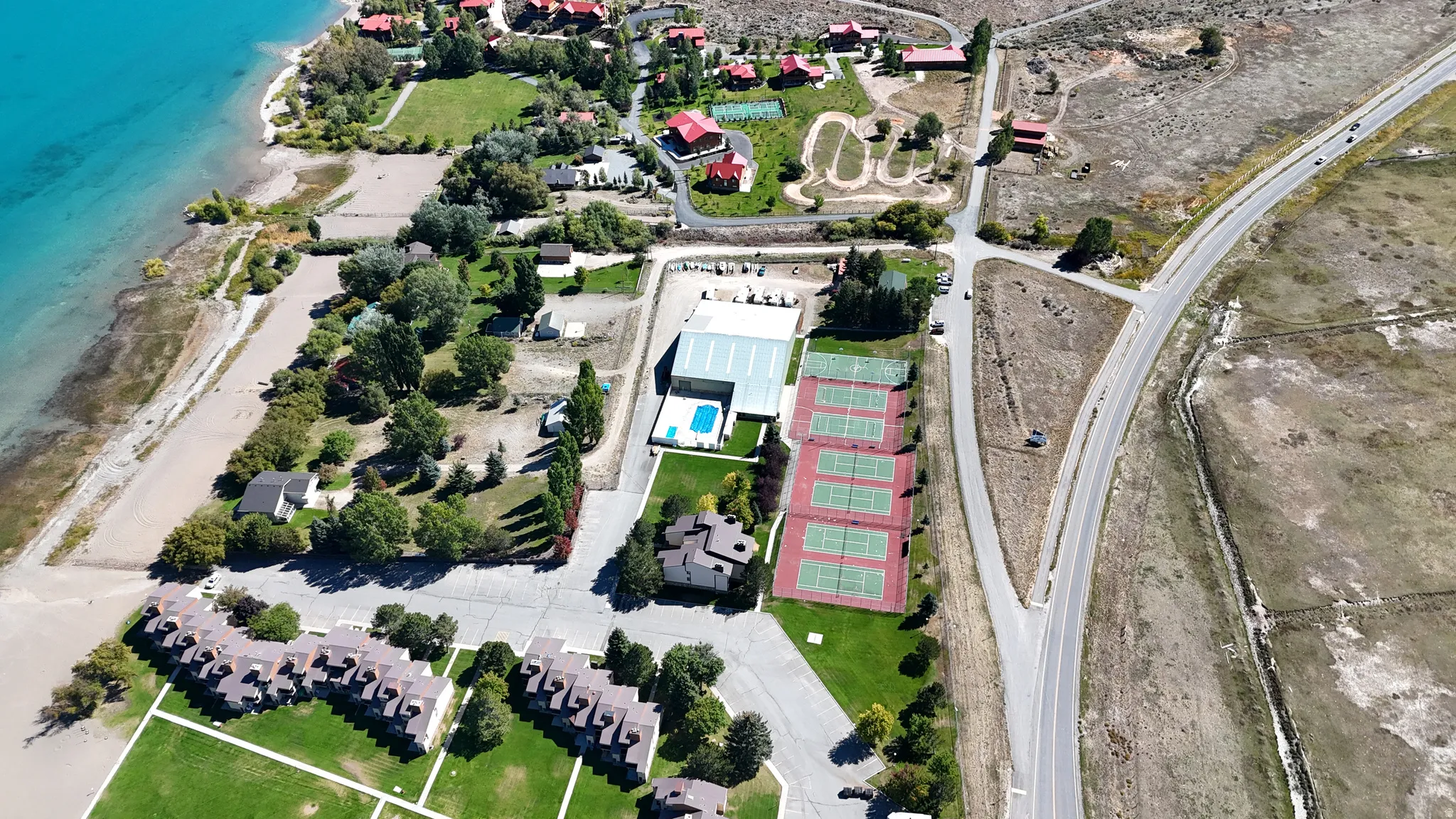 Aerial view of property's location featuring extended beach