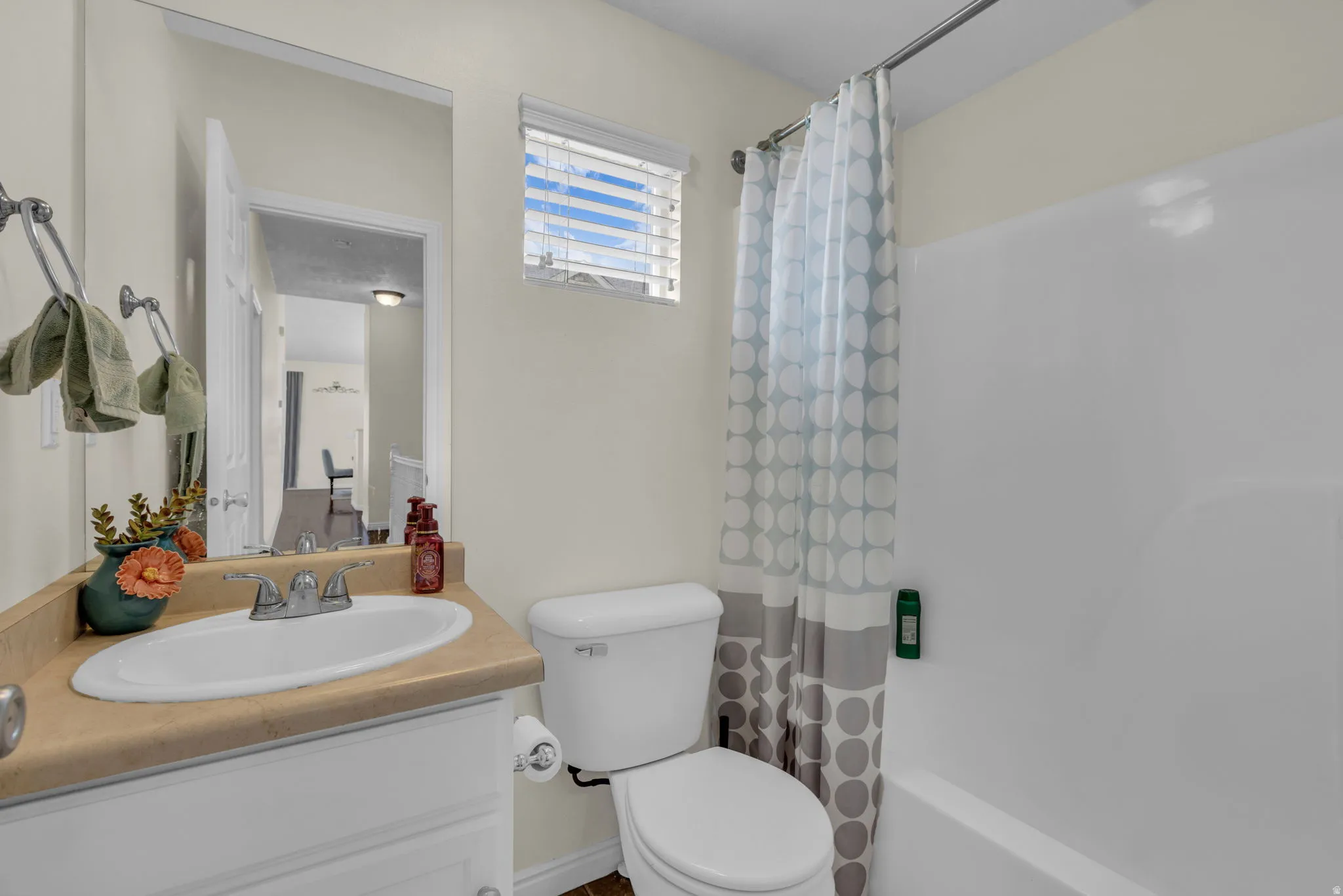 Bathroom featuring vanity and shower / bath combo