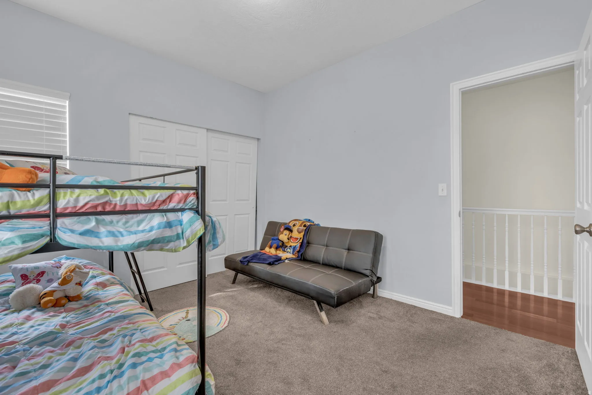 Carpeted bedroom featuring baseboards