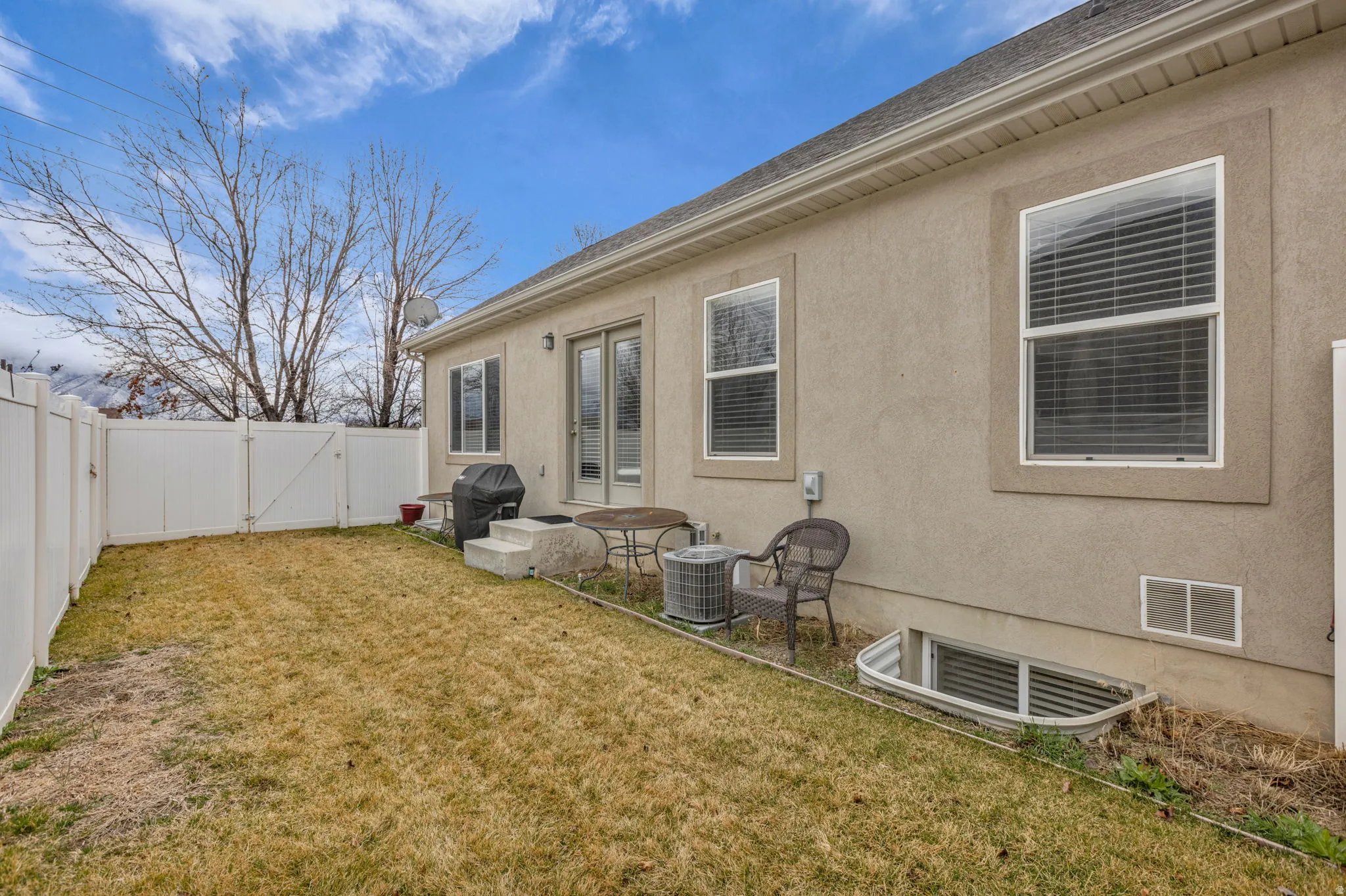 Fenced backyard featuring a gate, a patio, and french doors