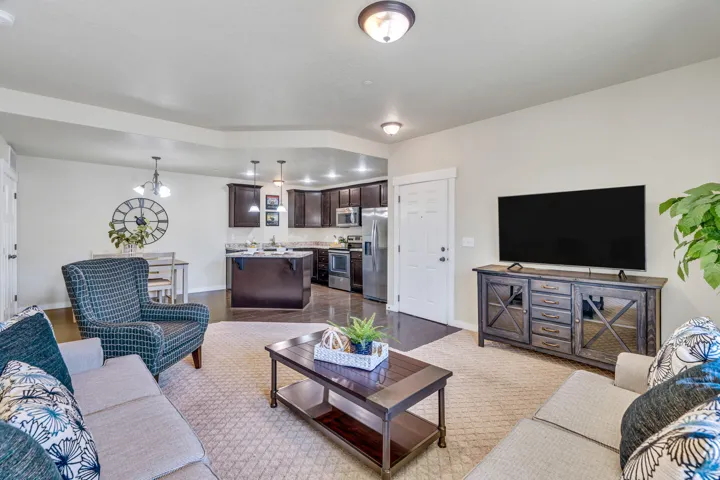 Living room with baseboards and suspended lighting