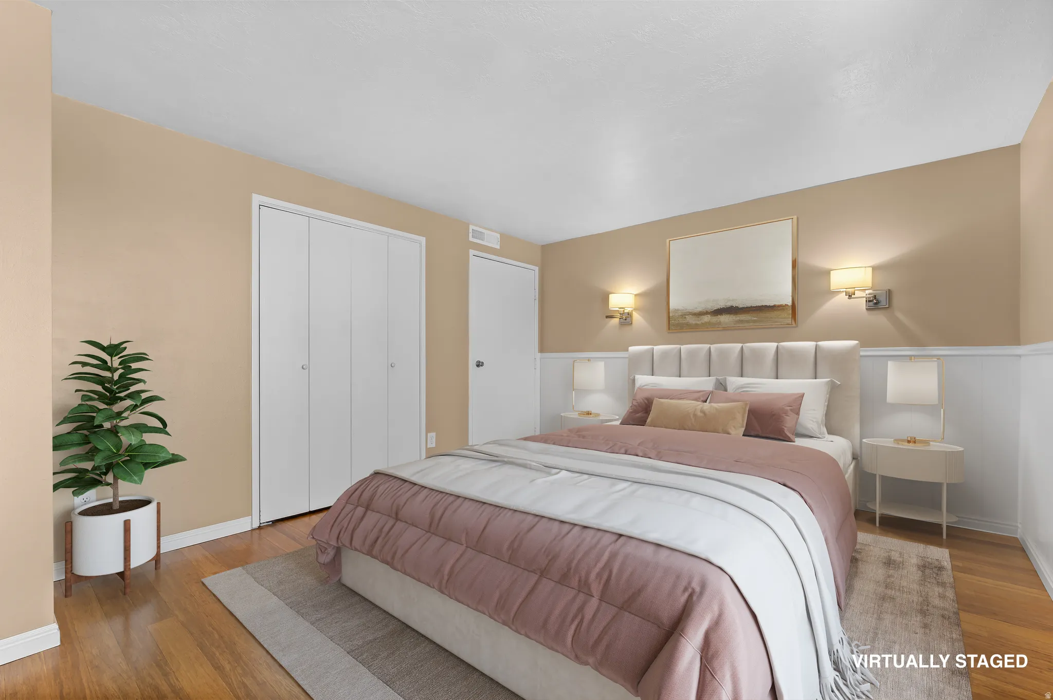 Bedroom featuring light wood-type flooring, a closet, and a wainscoted wall
