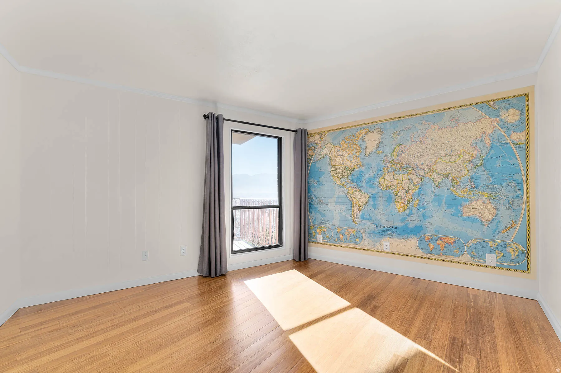 Unfurnished room with light wood-style floors and ornamental molding
