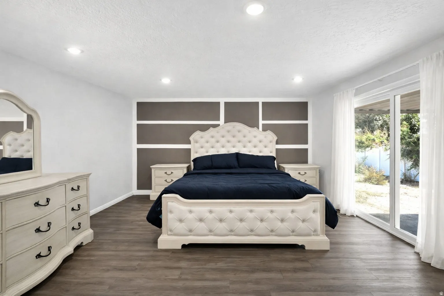 Bedroom featuring access to outside, dark wood finished floors, recessed lighting, and a textured ceiling
