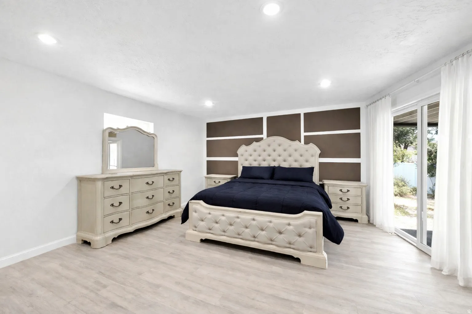Bedroom featuring access to outside, light wood finished floors, and recessed lighting