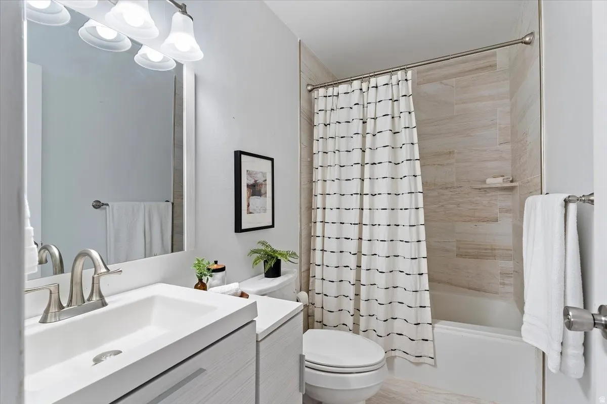 Full bathroom featuring vanity and shower / bath combination with curtain