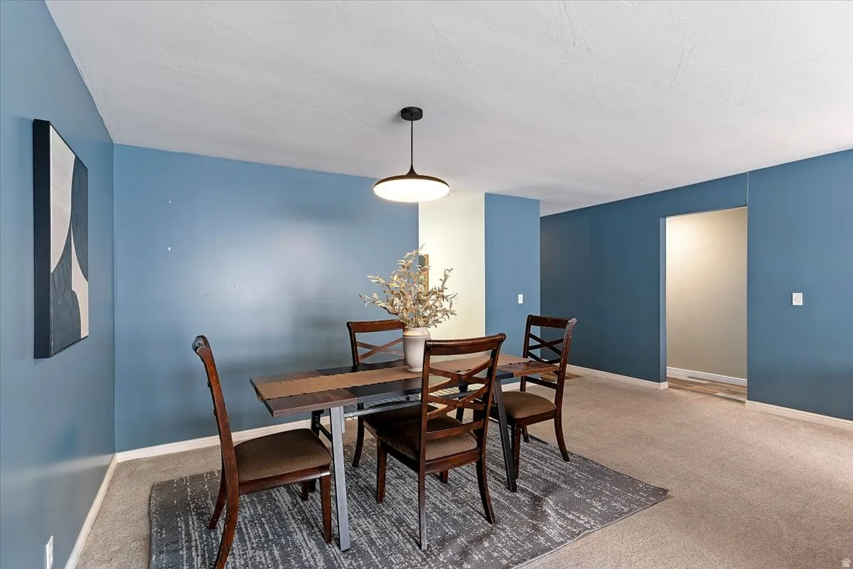 Dining space with carpet flooring and baseboards