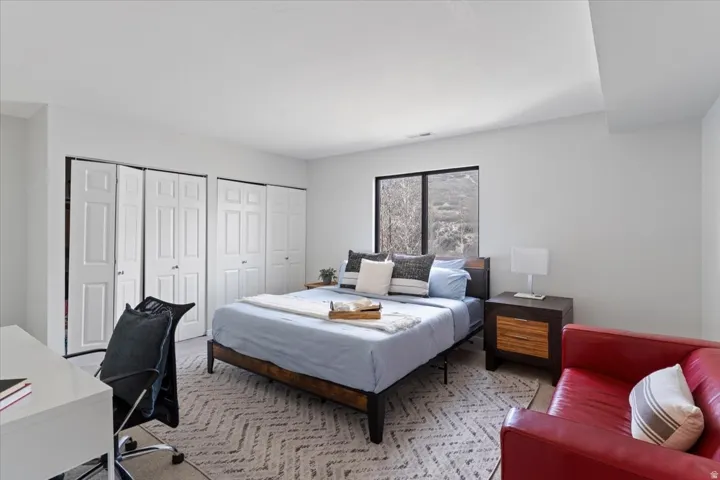 Bedroom with two closets and an office area