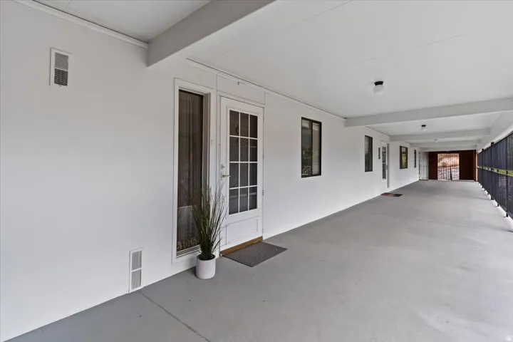 Property entrance featuring stucco siding