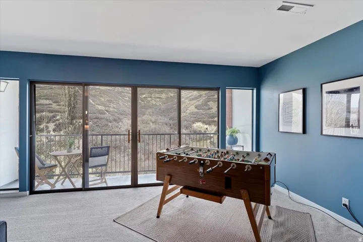 Game room with carpet and baseboards