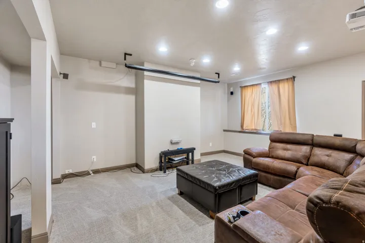 Living room with light carpet and recessed lighting