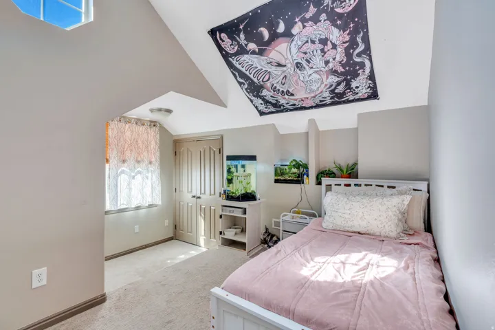 Bedroom featuring baseboards and light carpet