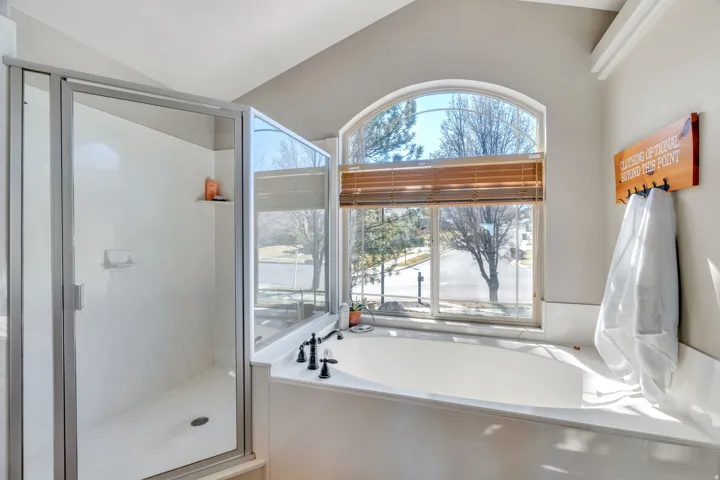 Bathroom featuring a garden tub and a stall shower