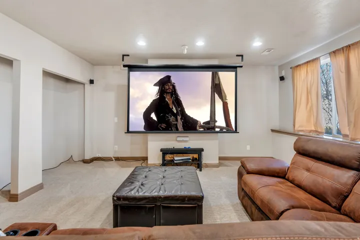 Cinema room featuring light carpet and recessed lighting
