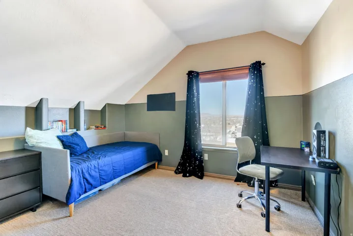 Bedroom with carpet and a desk