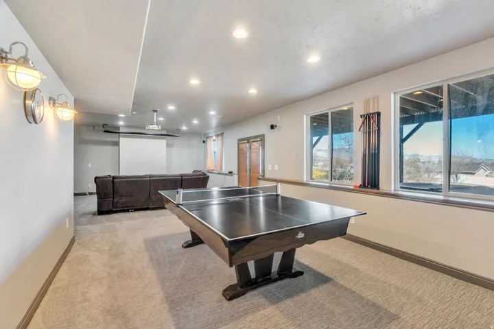 Rec room with light carpet and recessed lighting