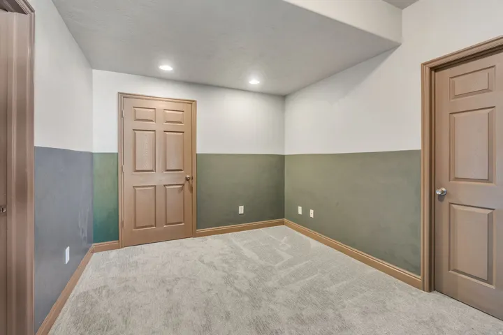 Bottom of stairs in basement, leading to cold storage, and utilities