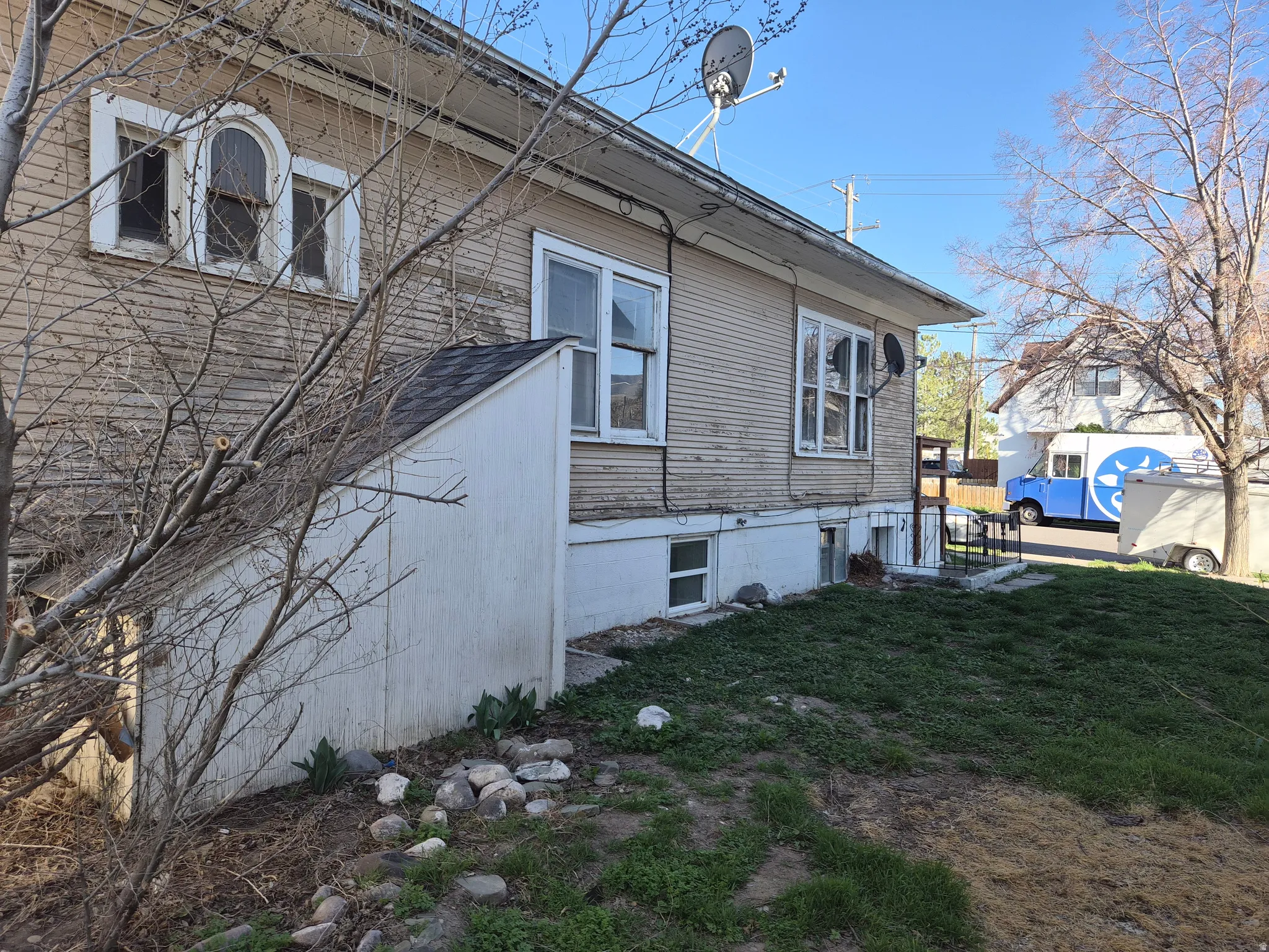 View of property exterior with a lawn