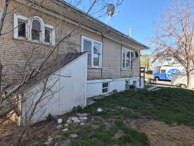 View of property exterior with a lawn