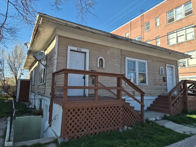 View of front of home with a wooden deck