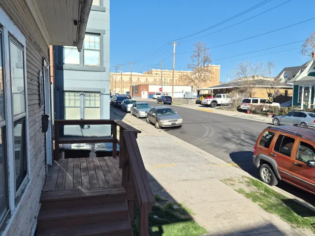 View of asphalt road featuring sidewalks