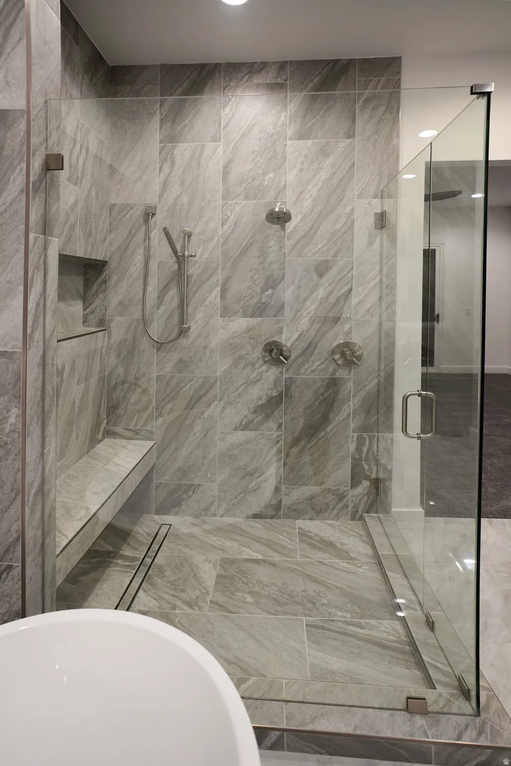 Full bathroom with a shower stall and a freestanding tub