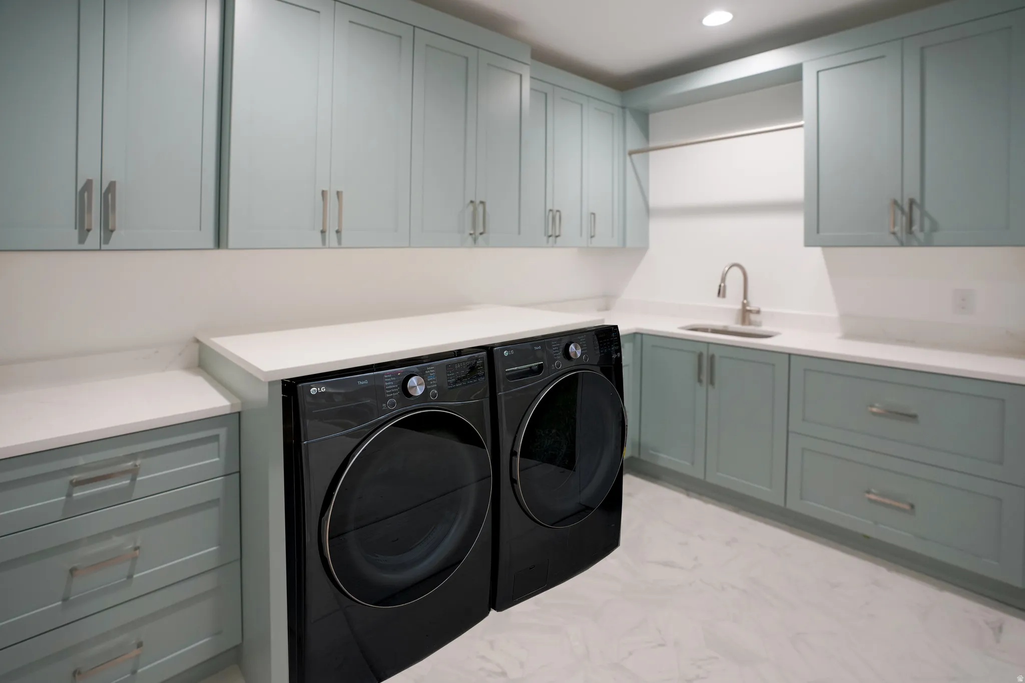 Laundry area with washing machine and dryer, cabinet space, and recessed lighting