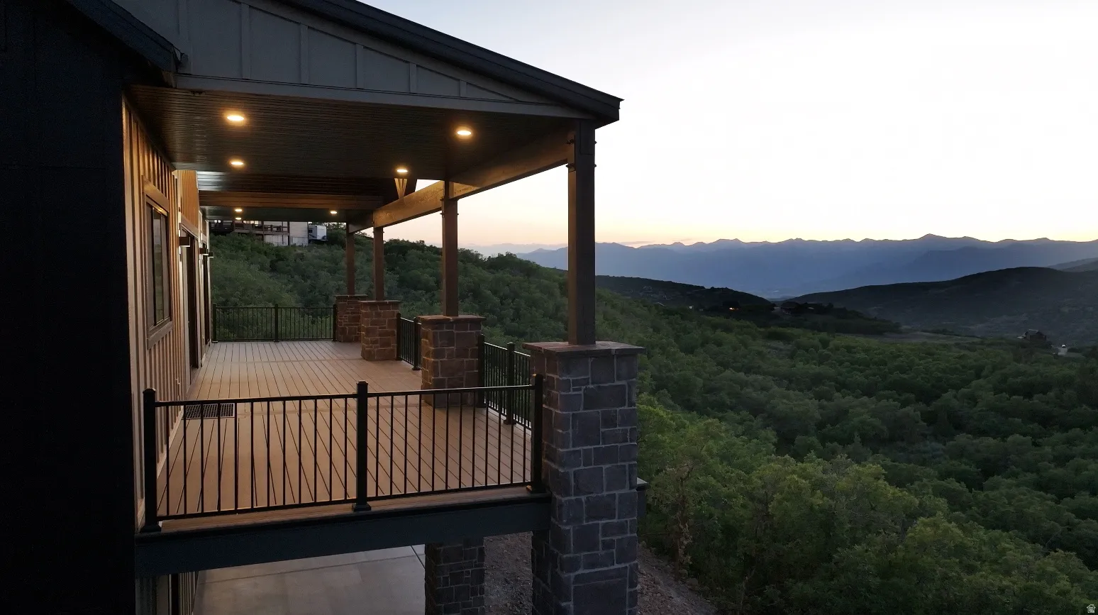 Patio terrace at dusk with a mountain view and a patio area