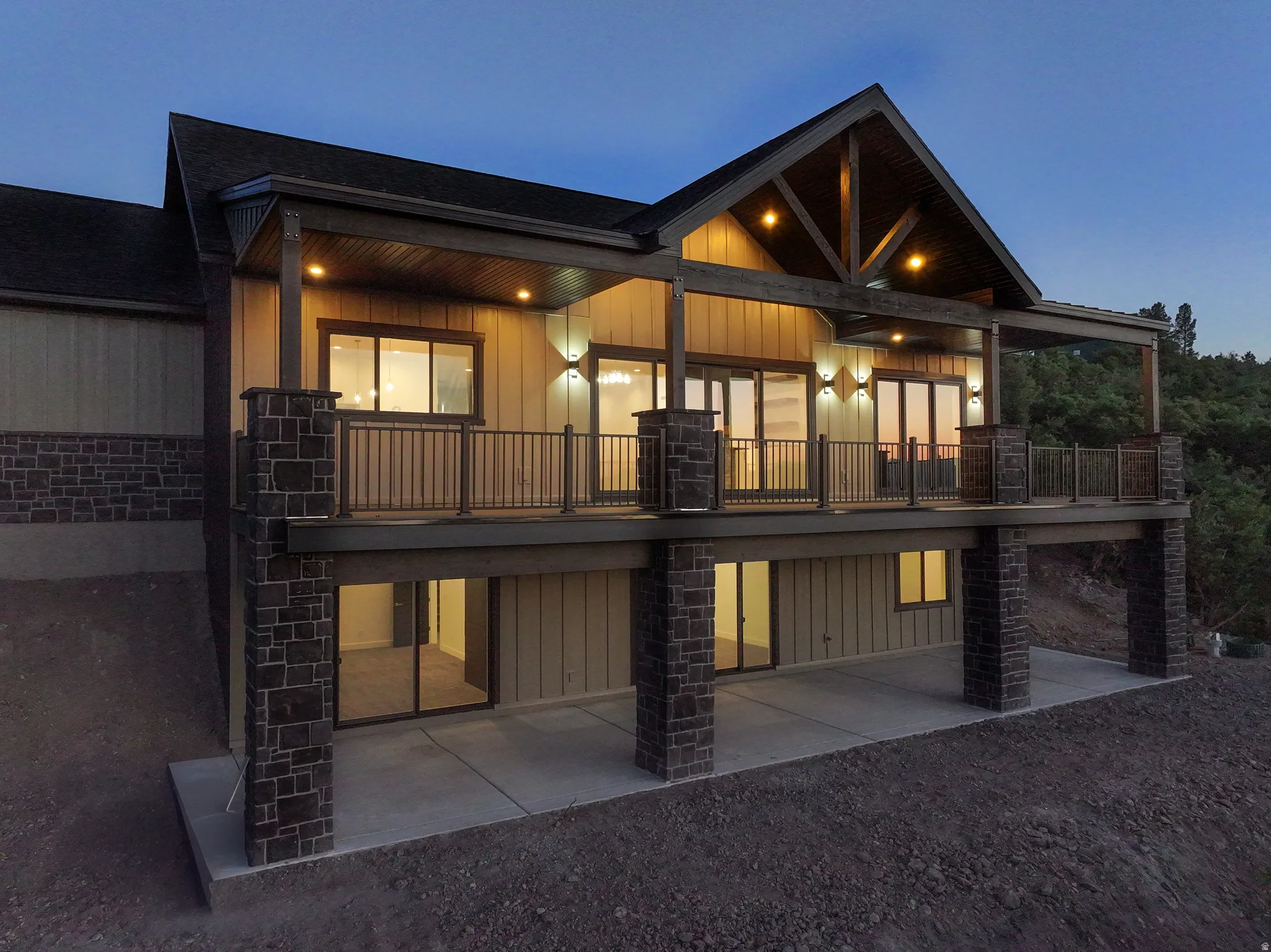 Back of house featuring board and batten siding and a patio