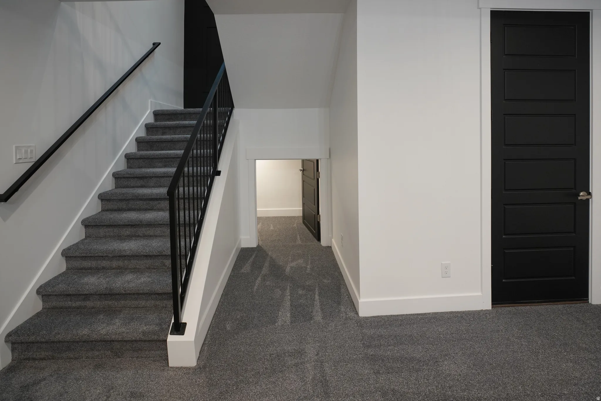 Staircase featuring carpet and baseboards