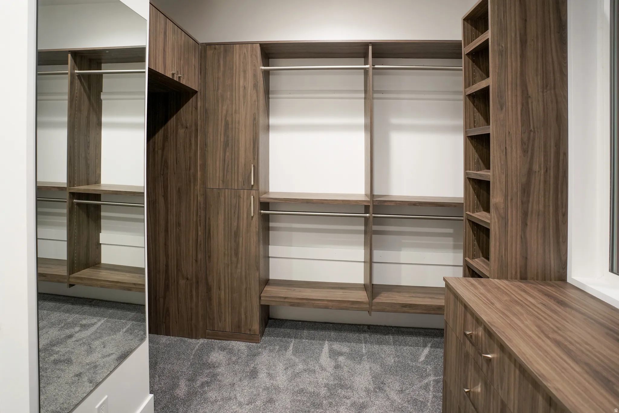 Walk in closet featuring dark carpet