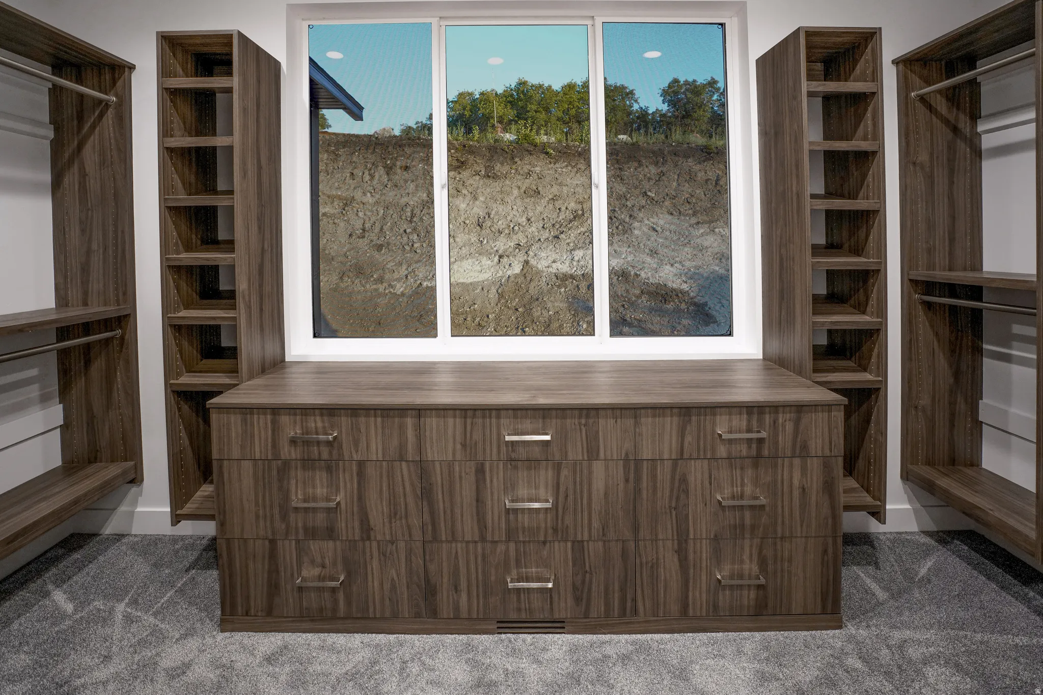 Walk in closet featuring dark carpet