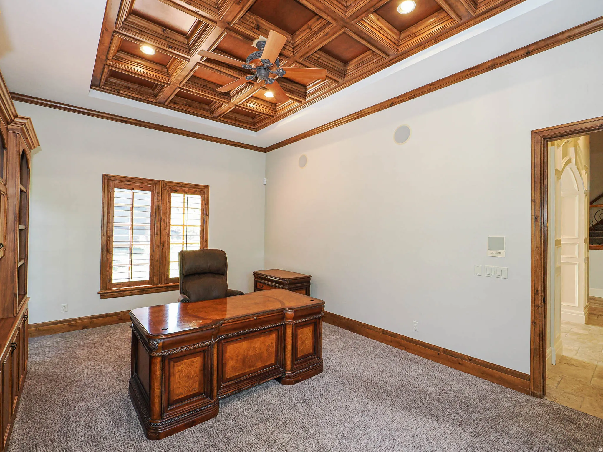 Office with crown molding, coffered ceiling, a ceiling fan, recessed lighting, and carpet floors