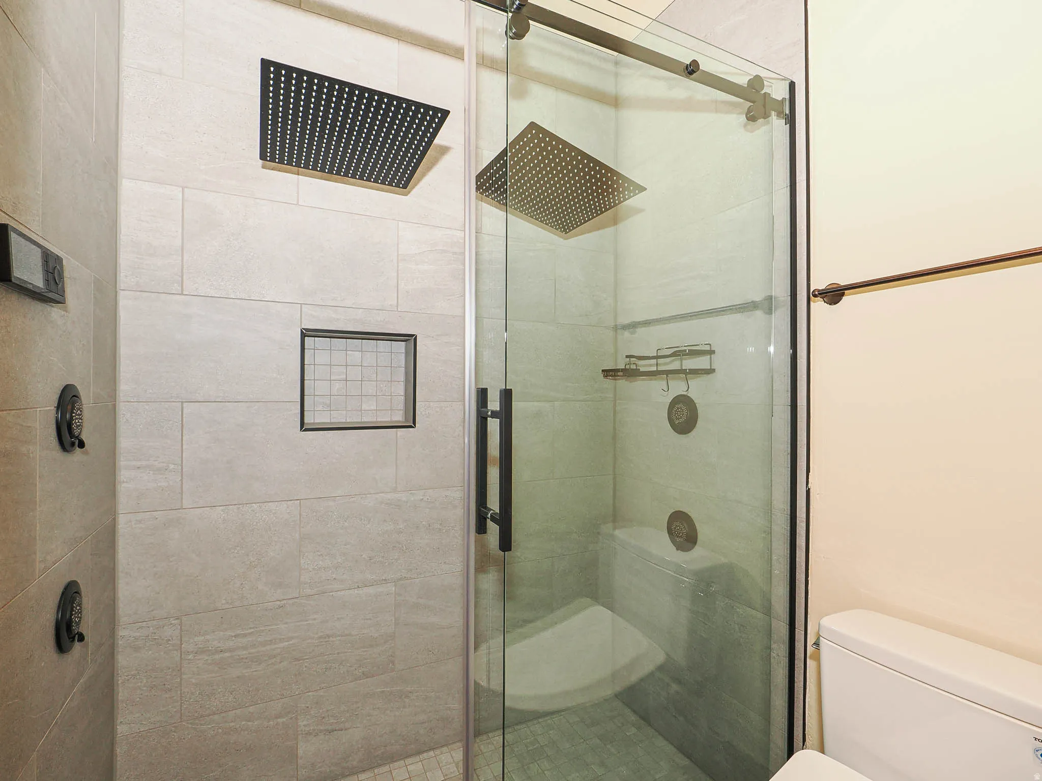 Bathroom featuring toilet and a stall shower