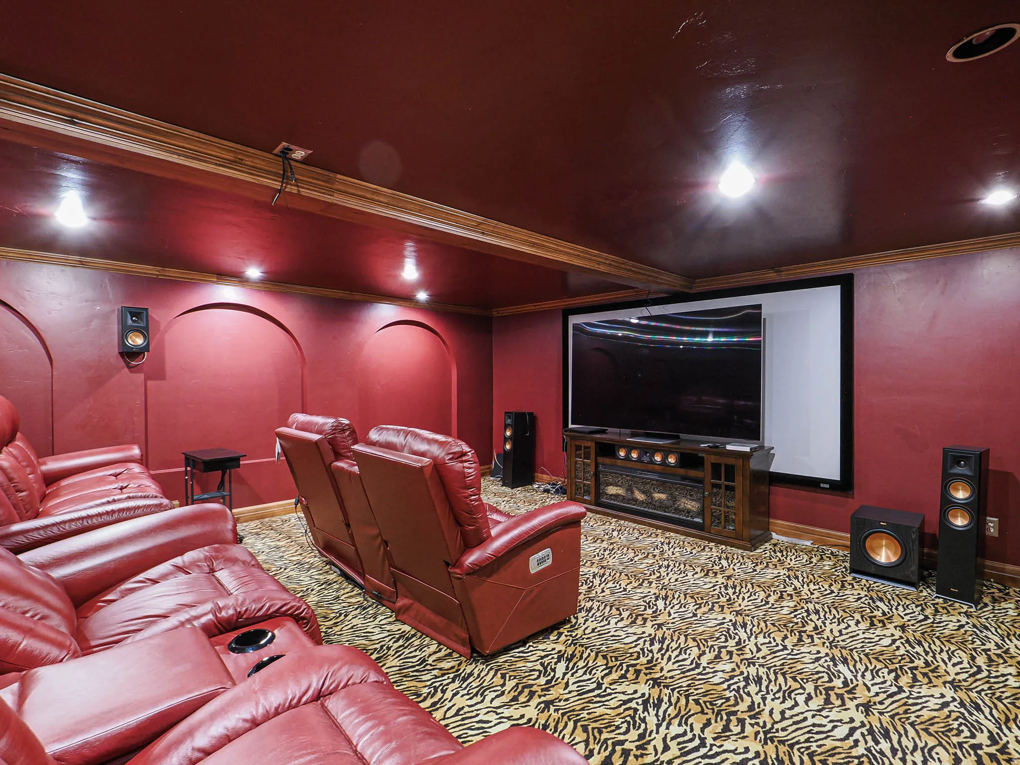 Home theater with ornamental molding and carpet