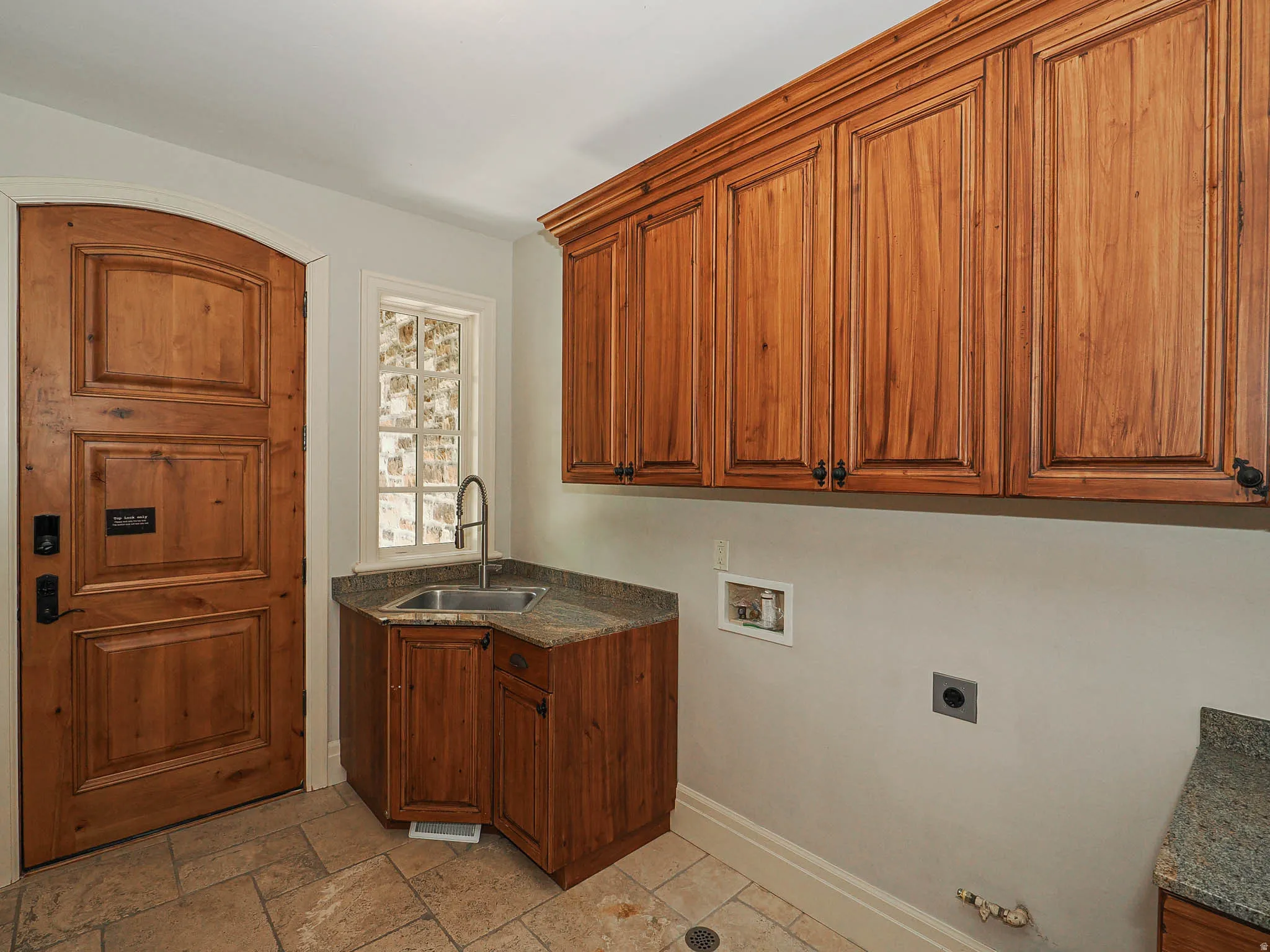 Laundry area with washer hookup, cabinet space, stone tile flooring, hookup for an electric dryer, and hookup for a gas dryer