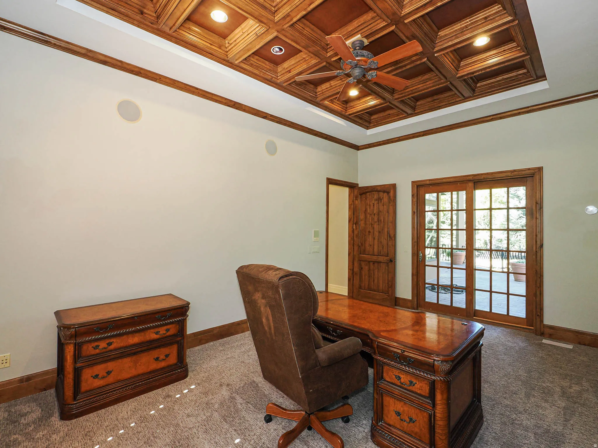 Carpeted home office featuring crown molding, coffered ceiling, a ceiling fan, recessed lighting, and wood ceiling