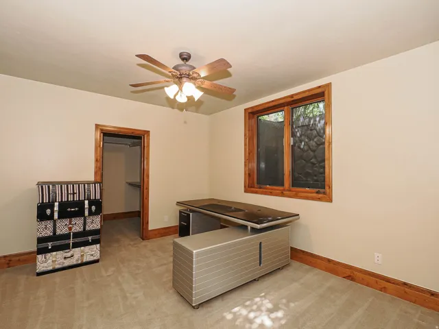 Playroom featuring light colored carpet and a ceiling fan